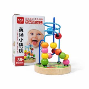 A colorful wooden bead maze toy with blue looping wire tracks and brightly colored round beads on a green wooden base, placed next to its packaging.