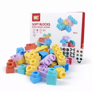 A 33-piece set of pastel-colored soft building blocks with its packaging and a sheet of eye and smile stickers.