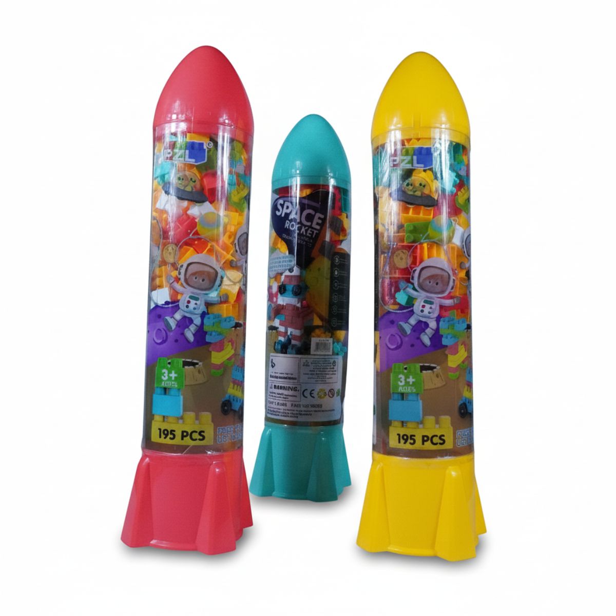 A tall rocket-shaped clear storage container filled with 195 colorful building blocks and wheels, with a pile of loose blocks at the base.